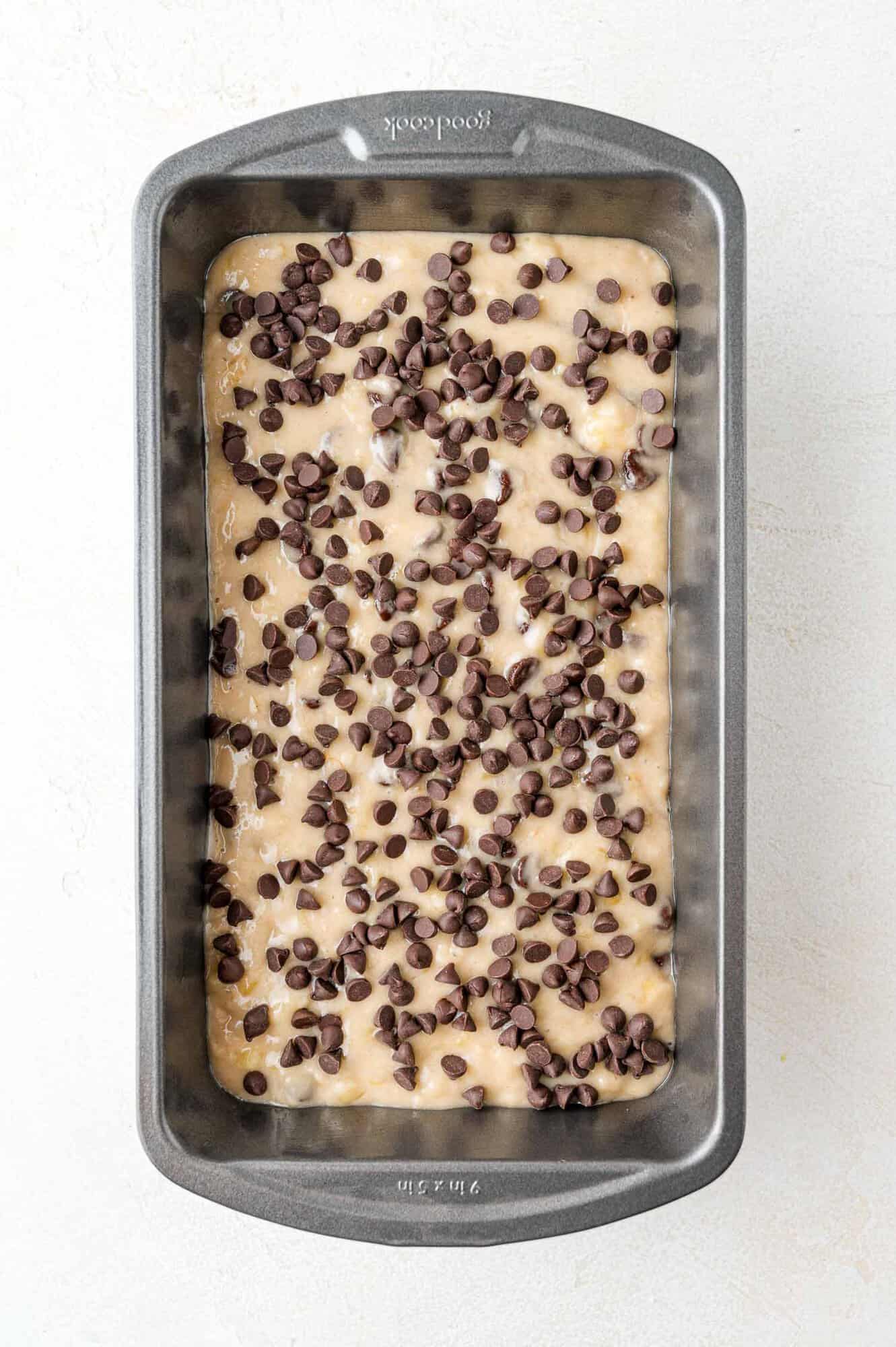 Unbaked bread topped with mini chocolate chips.