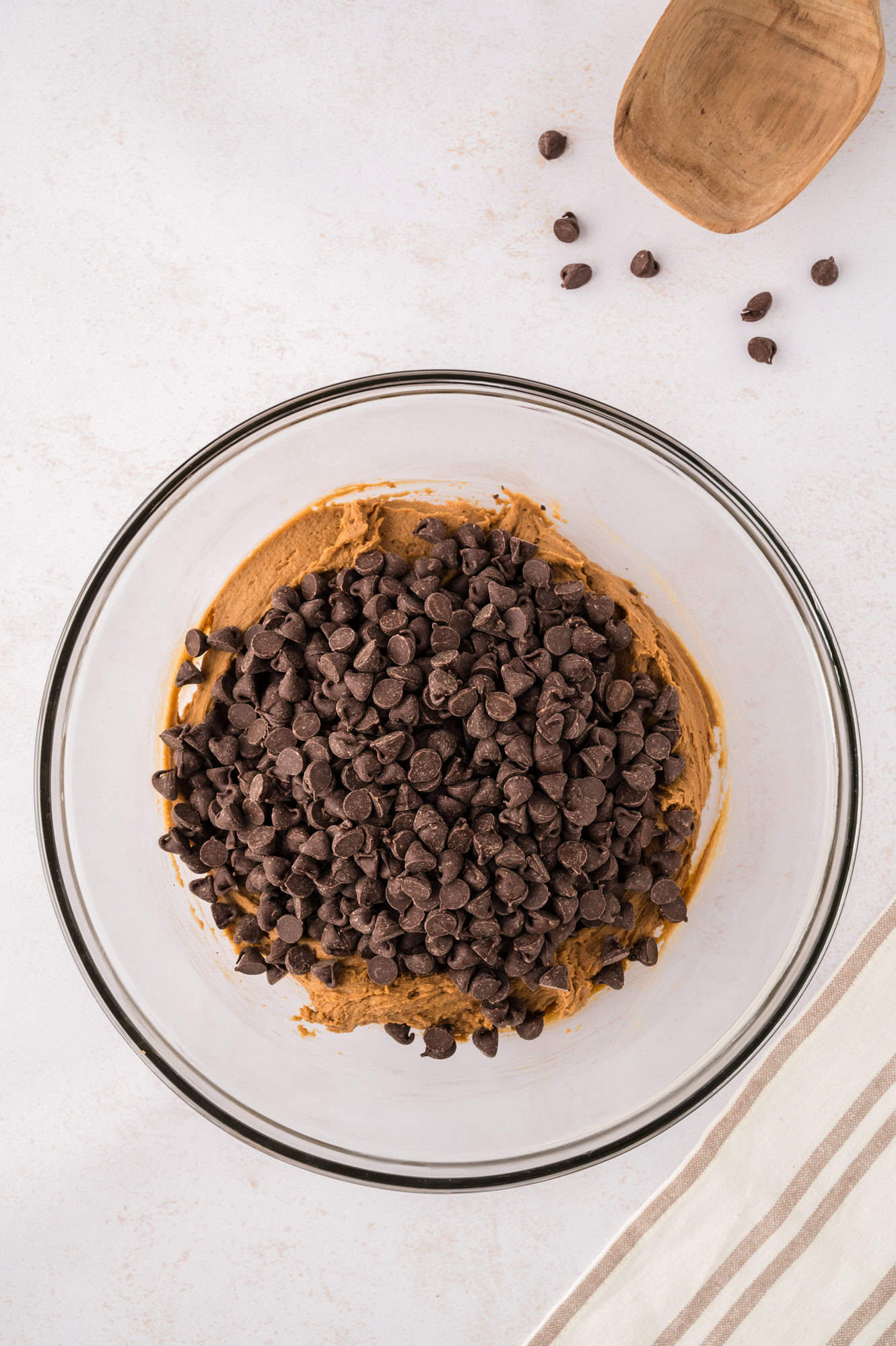 Chocolate chips added to dough, not yet mixed in.