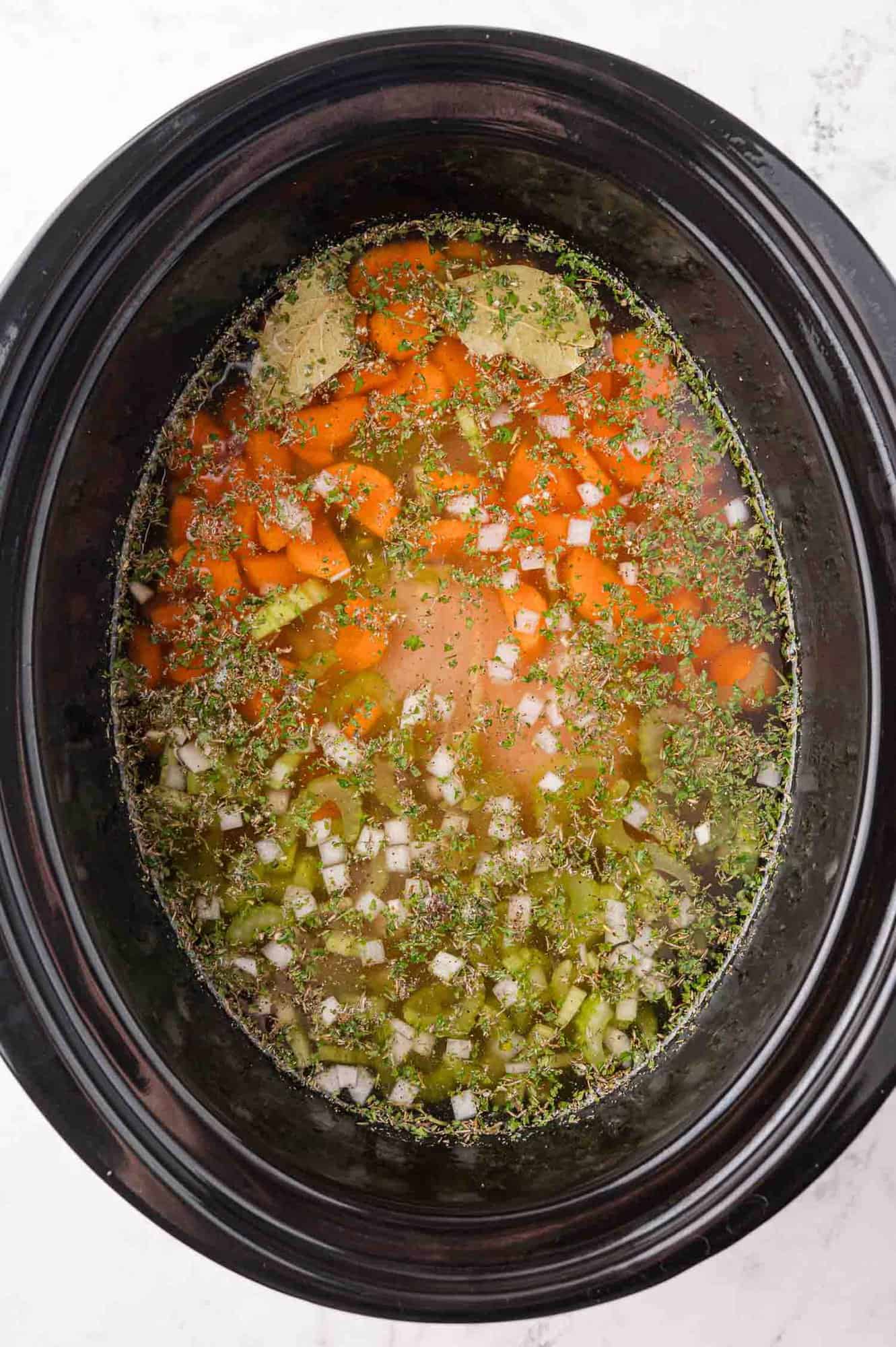 Ingredients mixed together in a crockpot, before cooking.