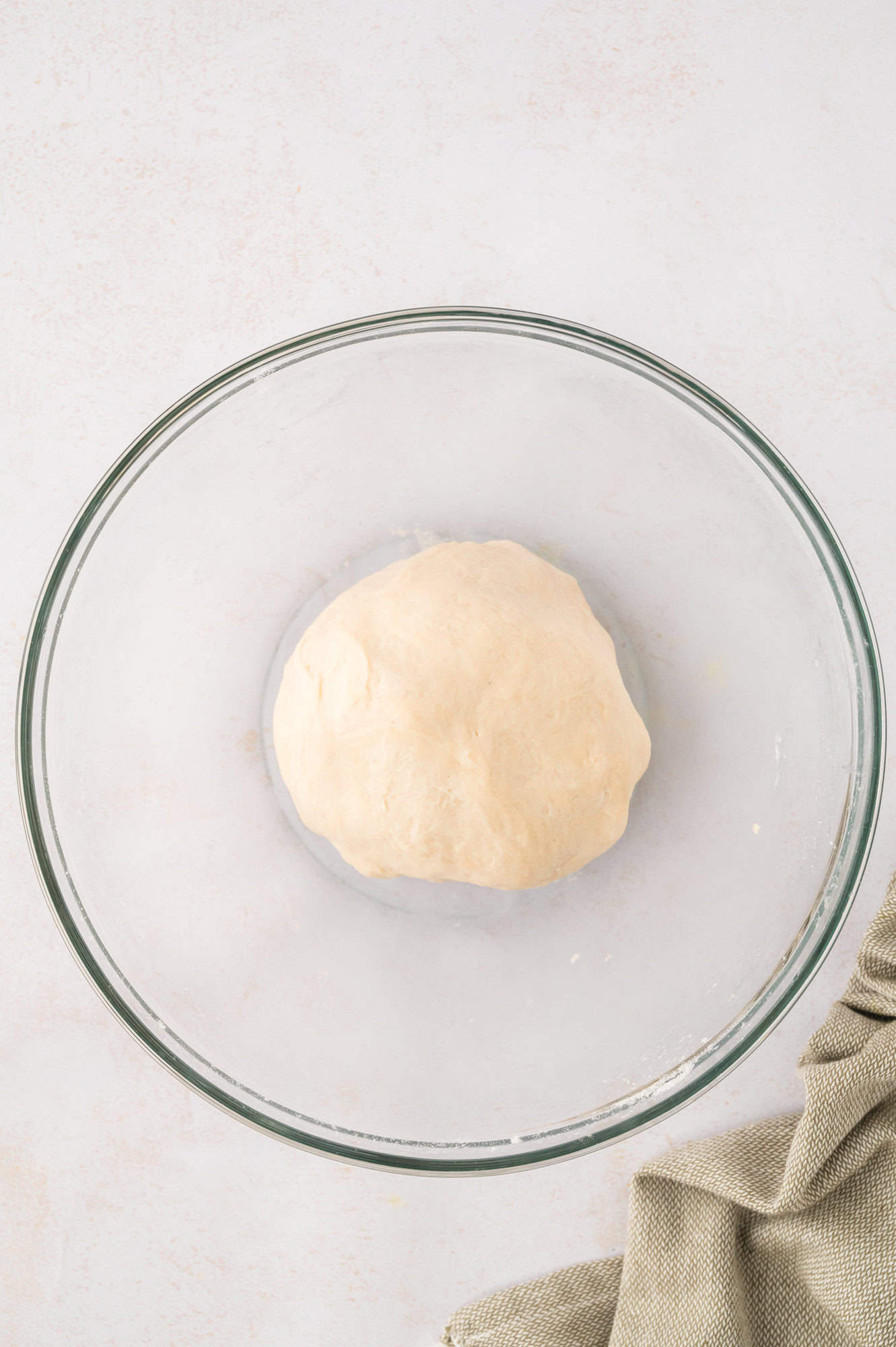 Tortilla dough formed into a ball, resting.