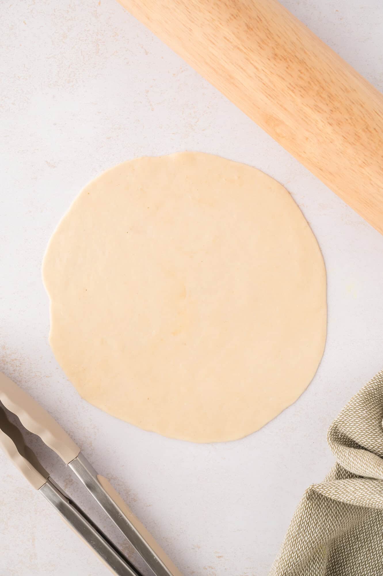 Tortilla dough rolled into a large circle.