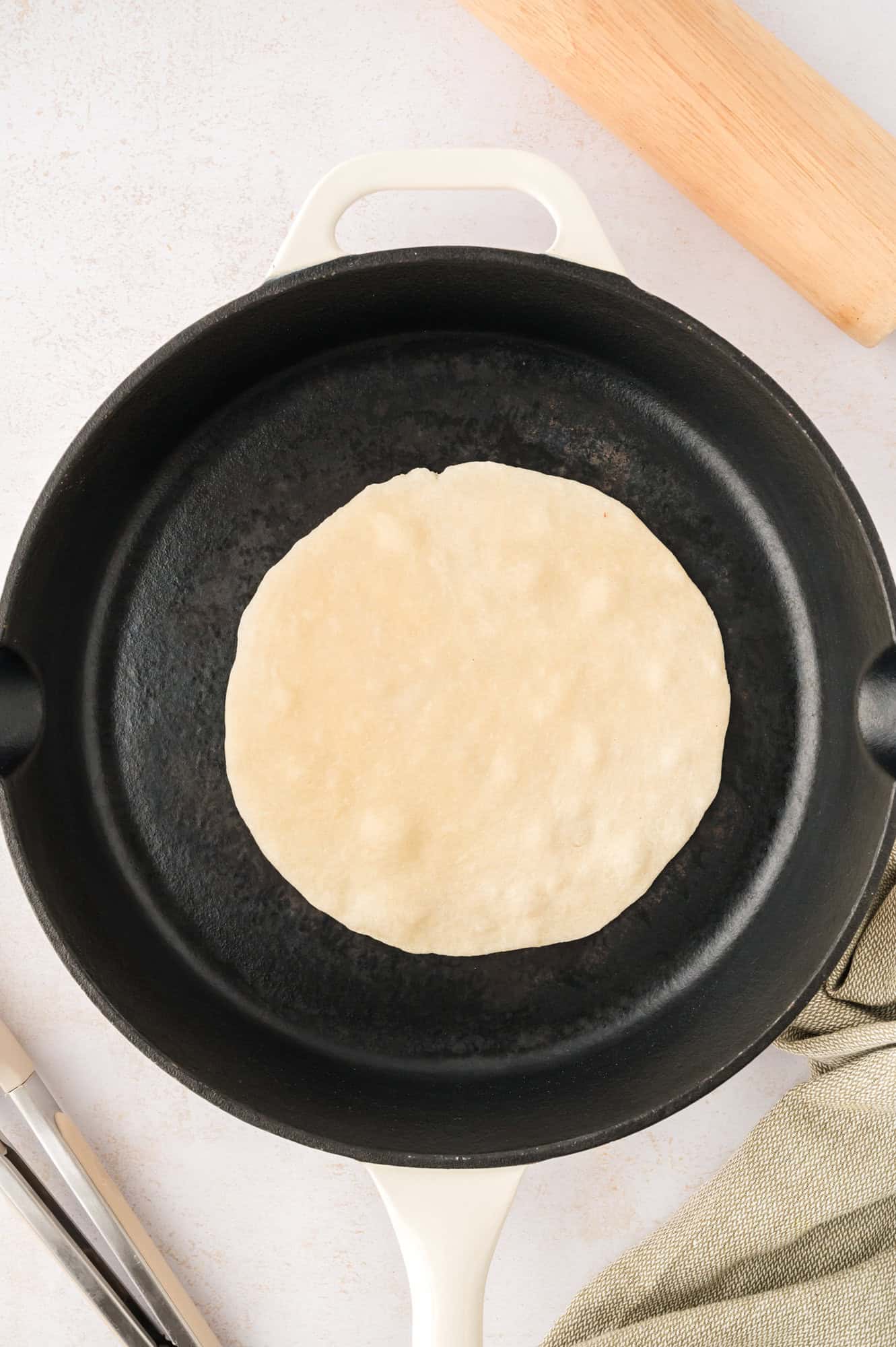 Tortilla in a cast iron pan, not yet cooked.