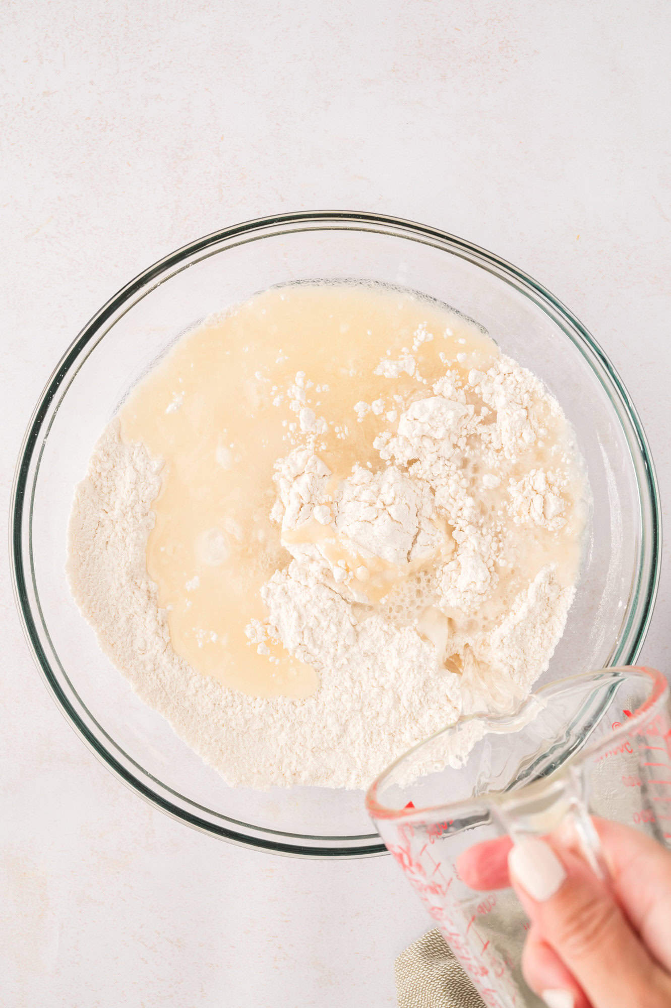 Water and shortening added to dry ingredients.