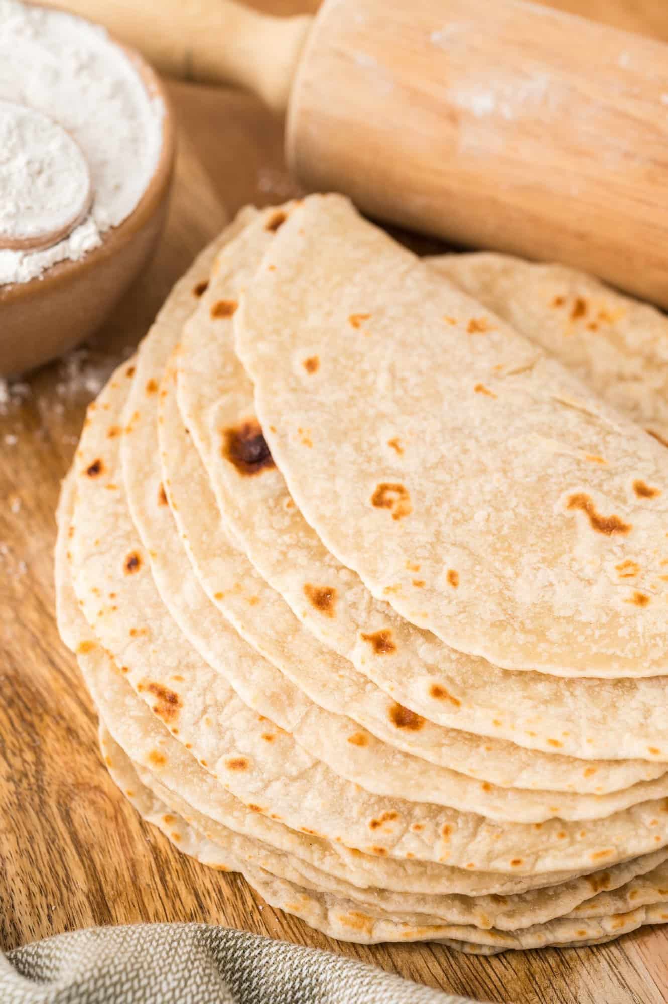 Homemade tortillas stacked up and partially folded over.