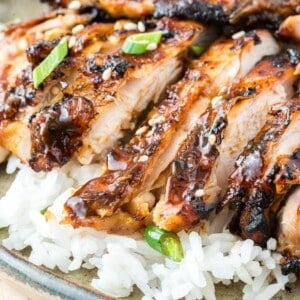 Ginger chicken thighs, sliced, and placed on top of rice.