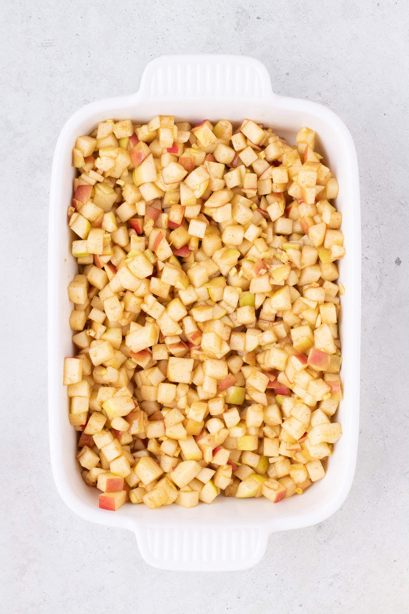 Apples added to baking dish.