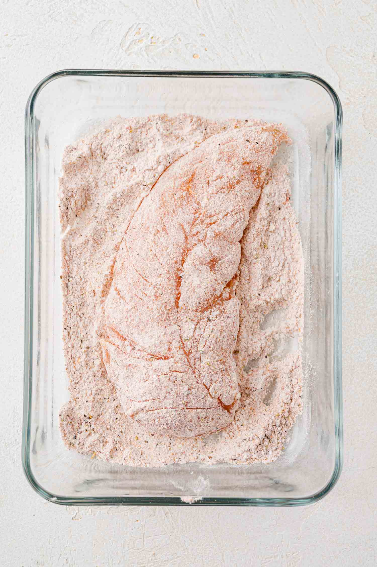 Chicken tender, coated in flour and seasonings.