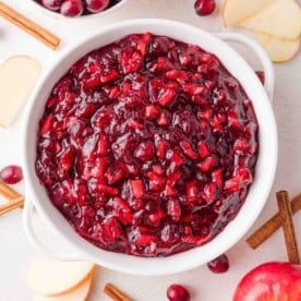 Apple cinnamon cranberry sauce in a white bowl, viewed from above.