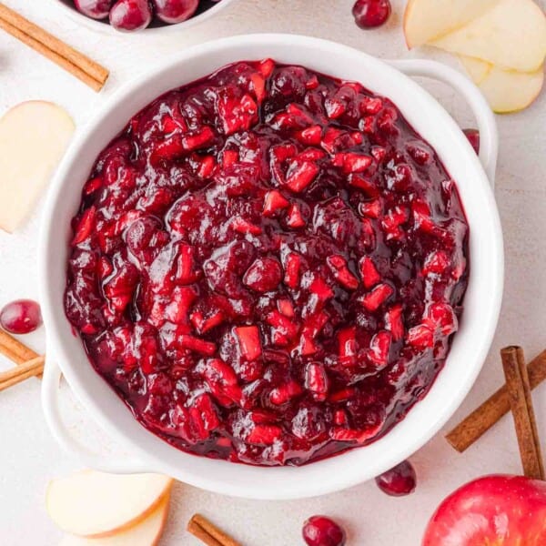 Apple cinnamon cranberry sauce in a white bowl, viewed from above.