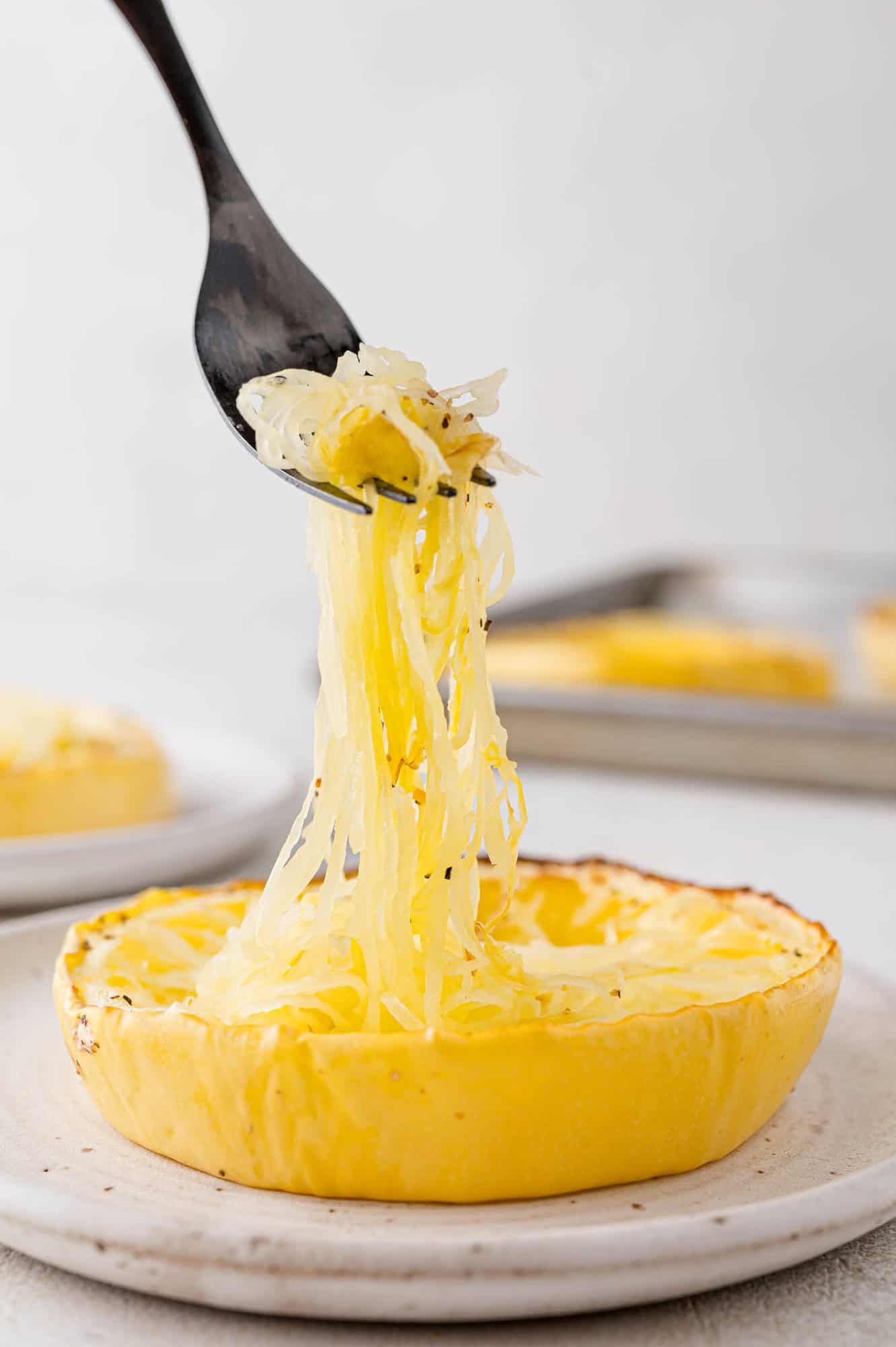 Strands of squash being lifted from squash.