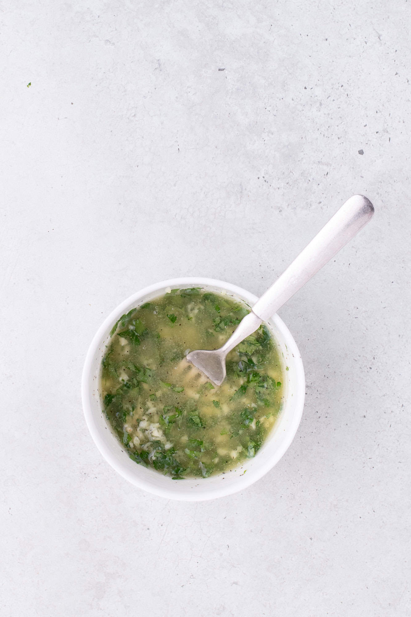 Garlic butter, mixed together in a small glass bowl.