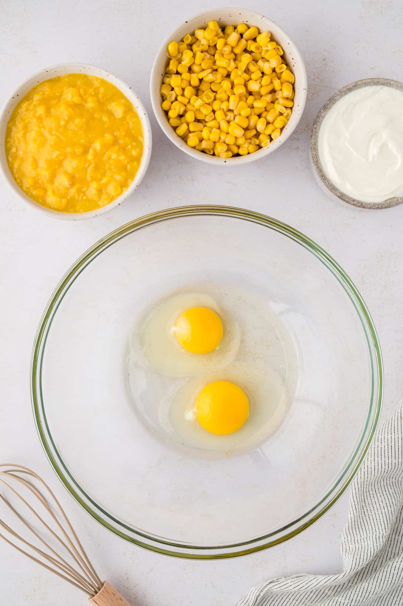 Eggs in clear glass mixing bowl.