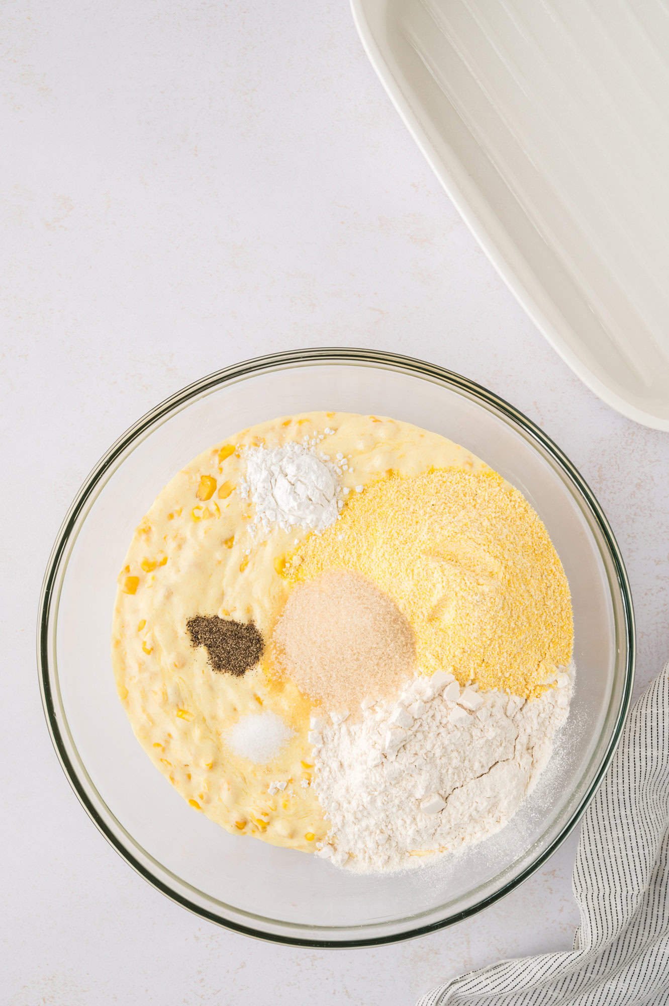 Dry ingredients added to wet ingredients, not yet mixed in.