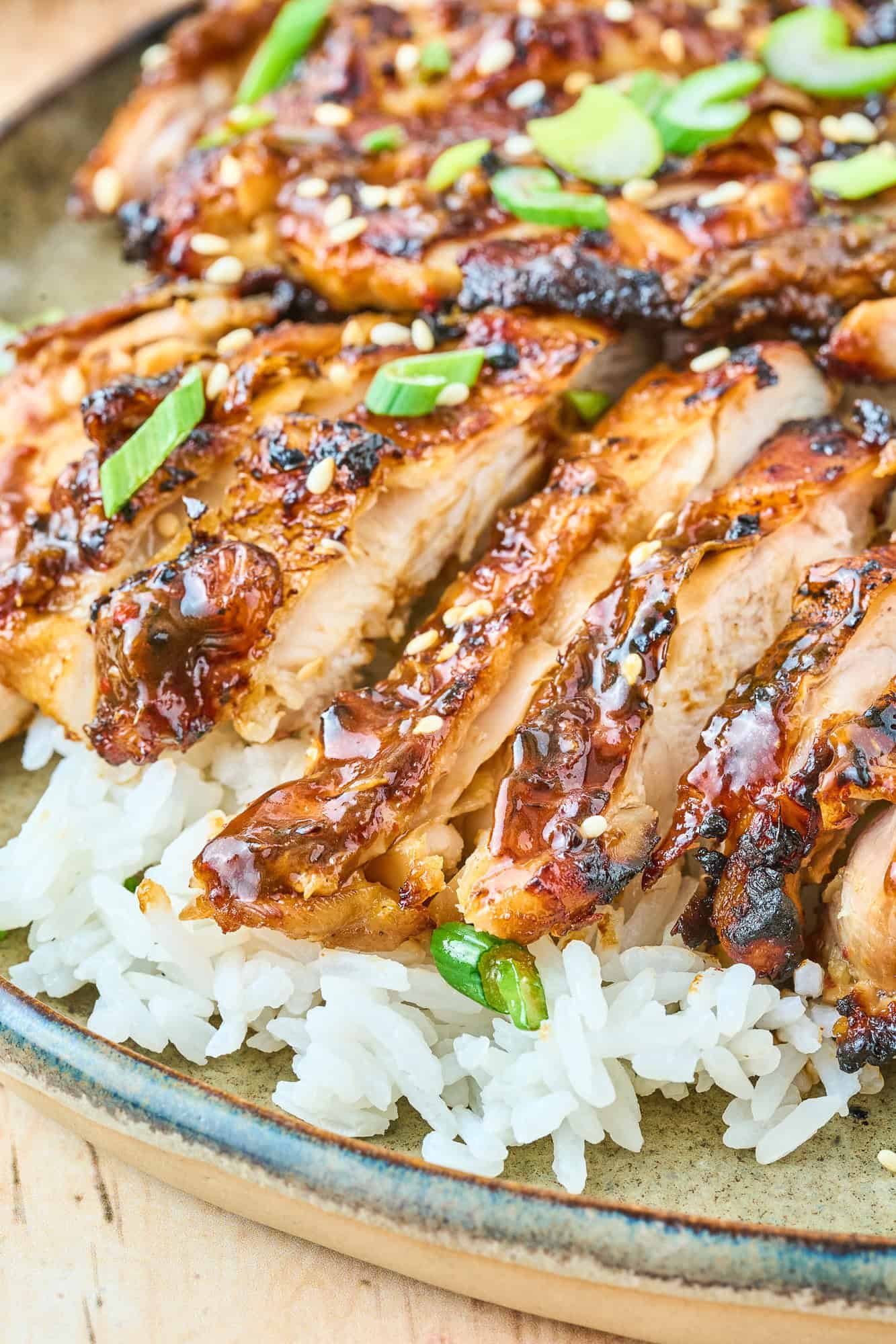 Ginger chicken thighs, sliced, and placed on top of rice.