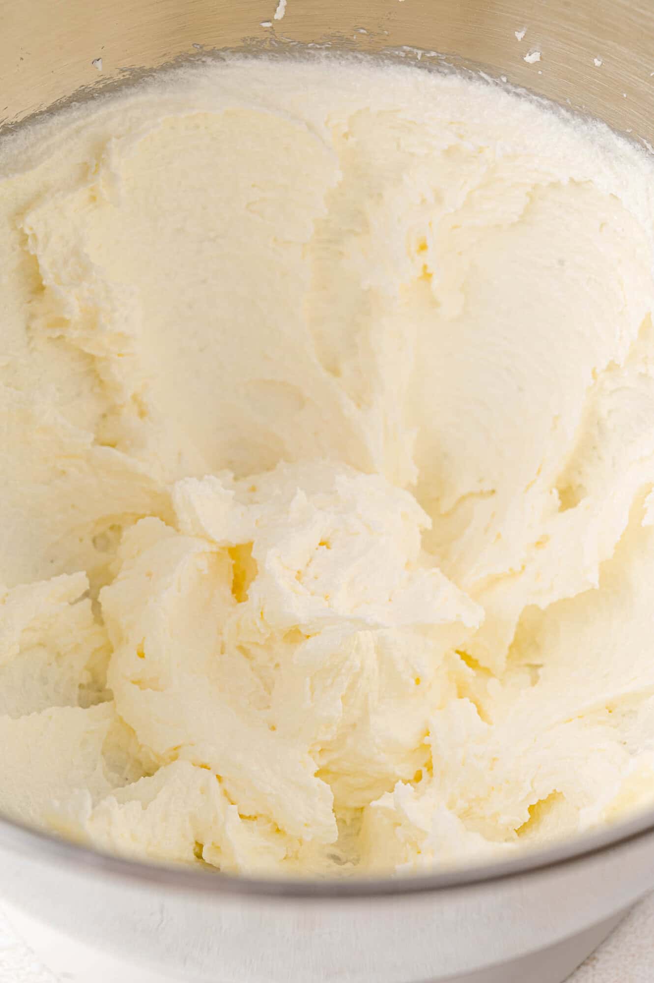 A mixing bowl filled with smooth, whipped cream-colored mixture.