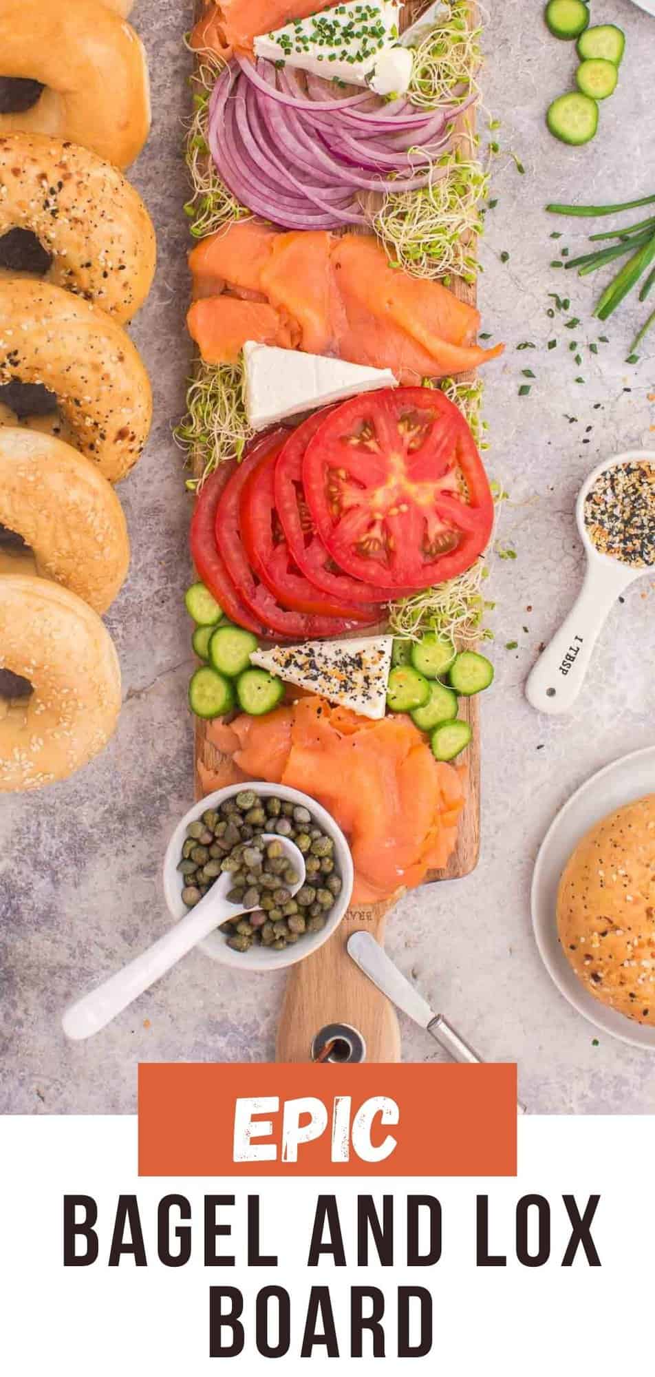 Bagel and lox board with smoked salmon, tomatoes, onions, alfalfa sprouts, cucumber slices, cream cheese, capers, and seasonings, accompanied by bagels.