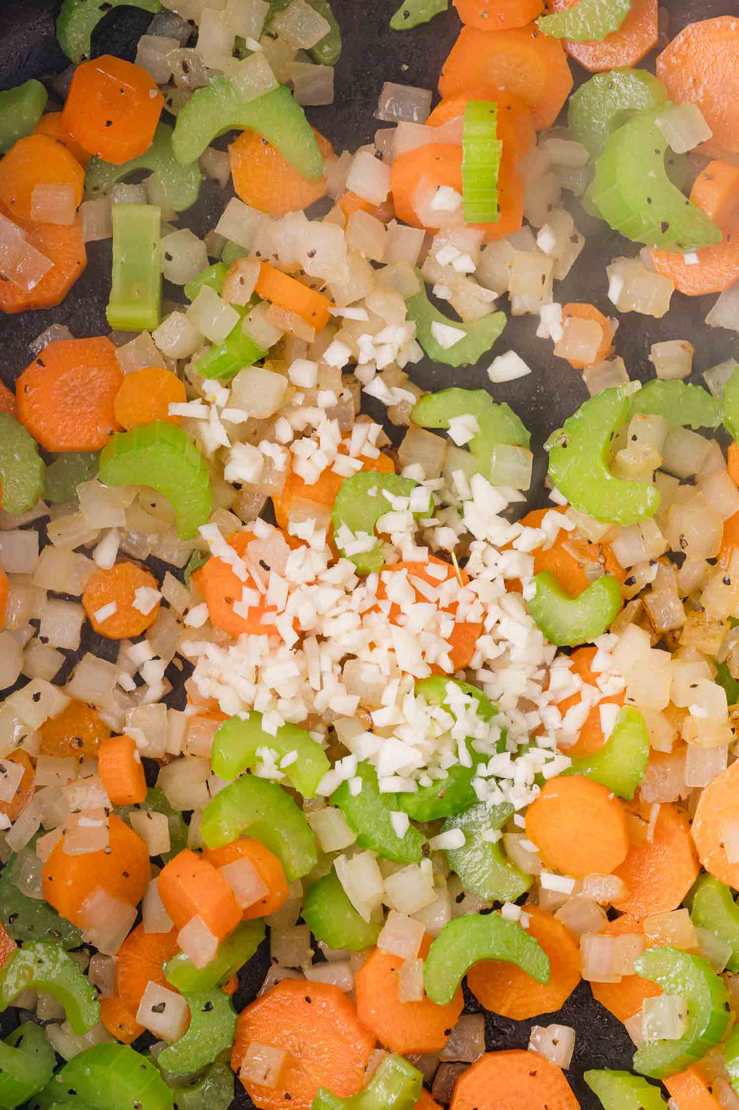 Black-Eyed Pea Soup 12 Chopped carrots, celery, onion, and minced garlic sautéing in a pan.