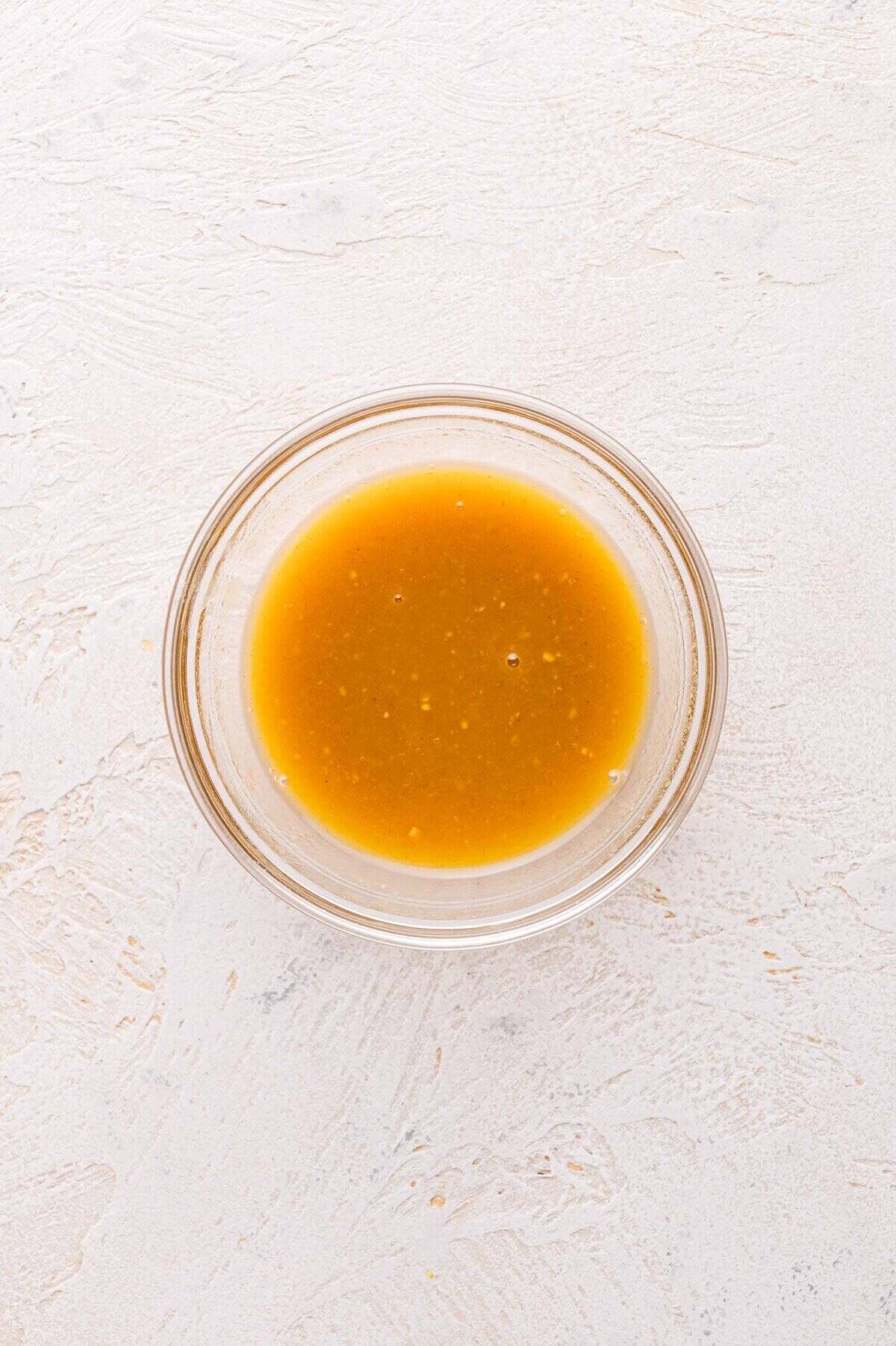 A small glass bowl containing maple mustard mixture.