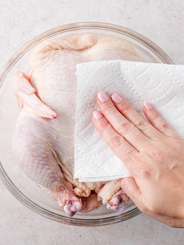 Chicken being patted dry.
