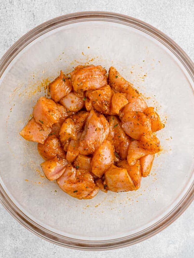 Raw chicken mixed with spices.