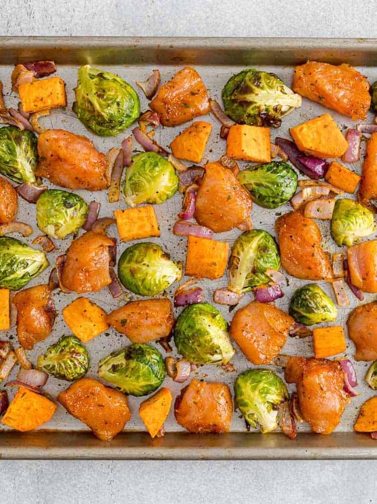 Vegetables and chicken on a sheet pan.