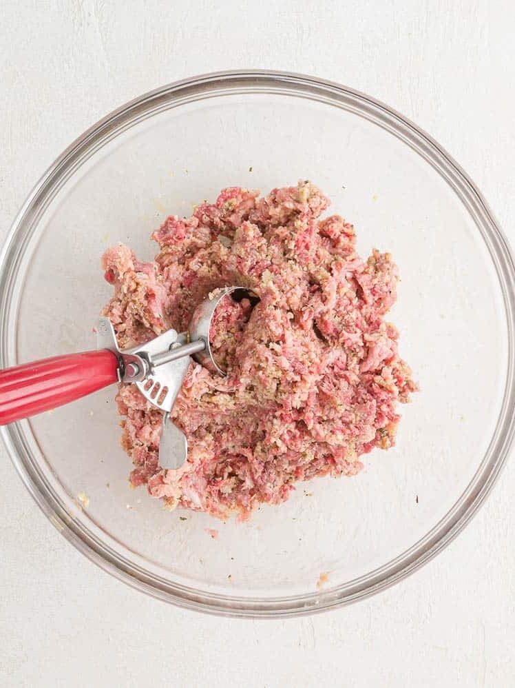 Scoop in meatball mixture.