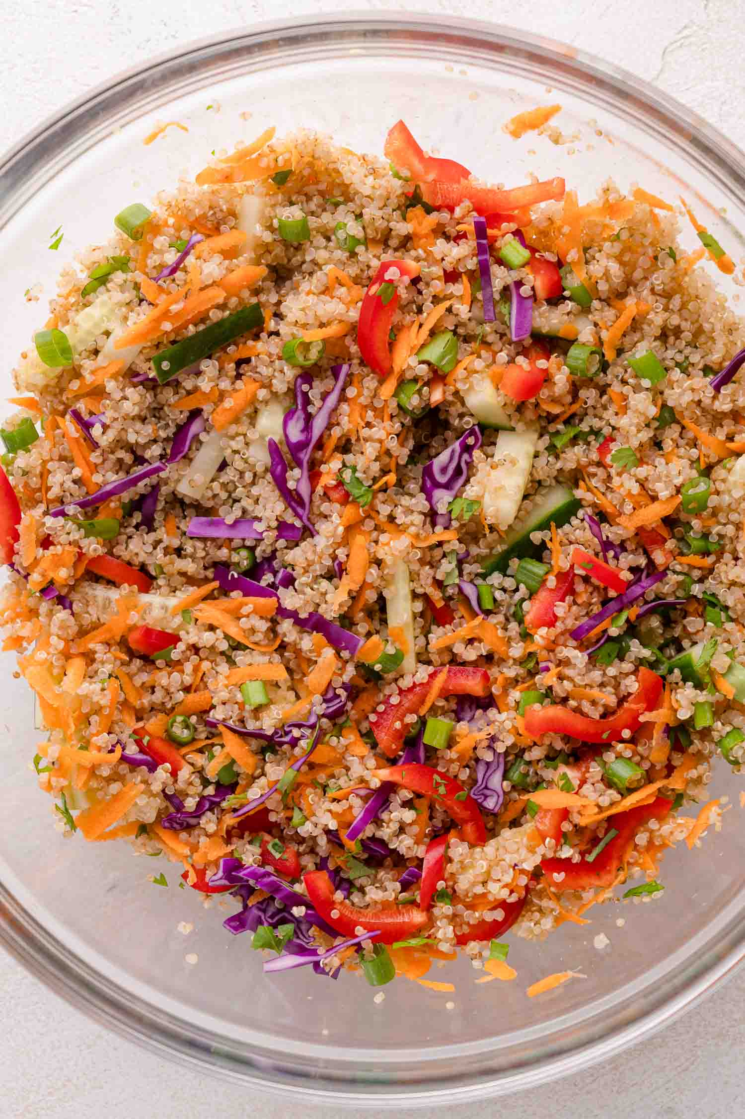 A bowl of quinoa, and colorful vegetables.