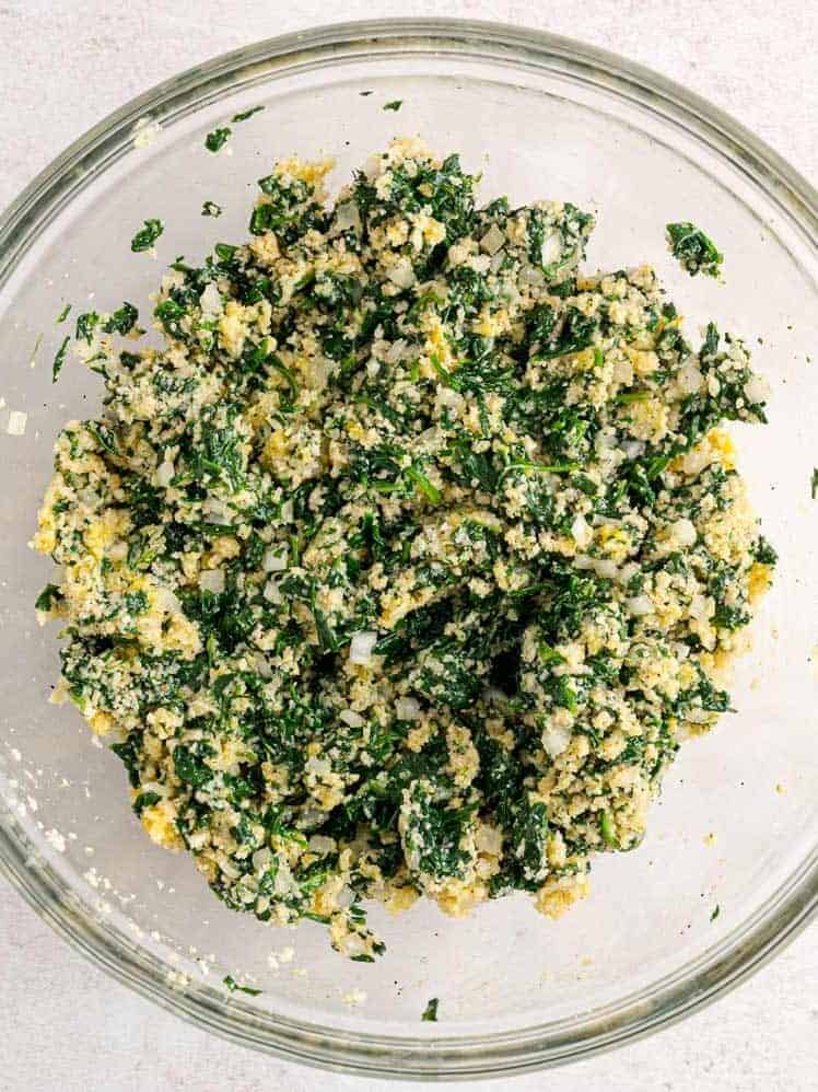 Spinach ball mixture in a glass bowl.