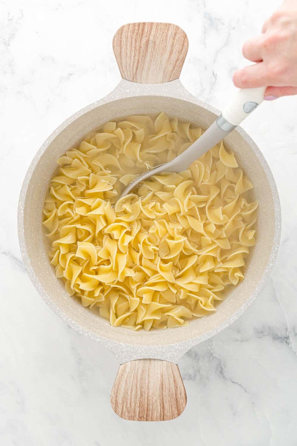 Cooked pasta in pot with water.