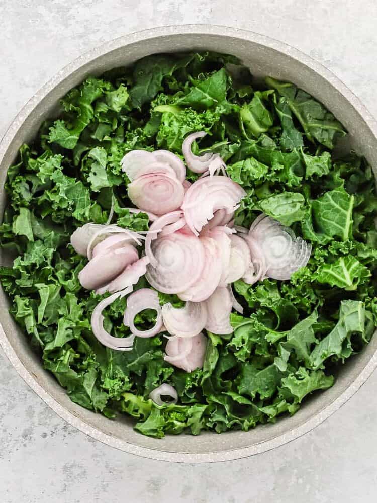 Uncooked kale and shallots.
