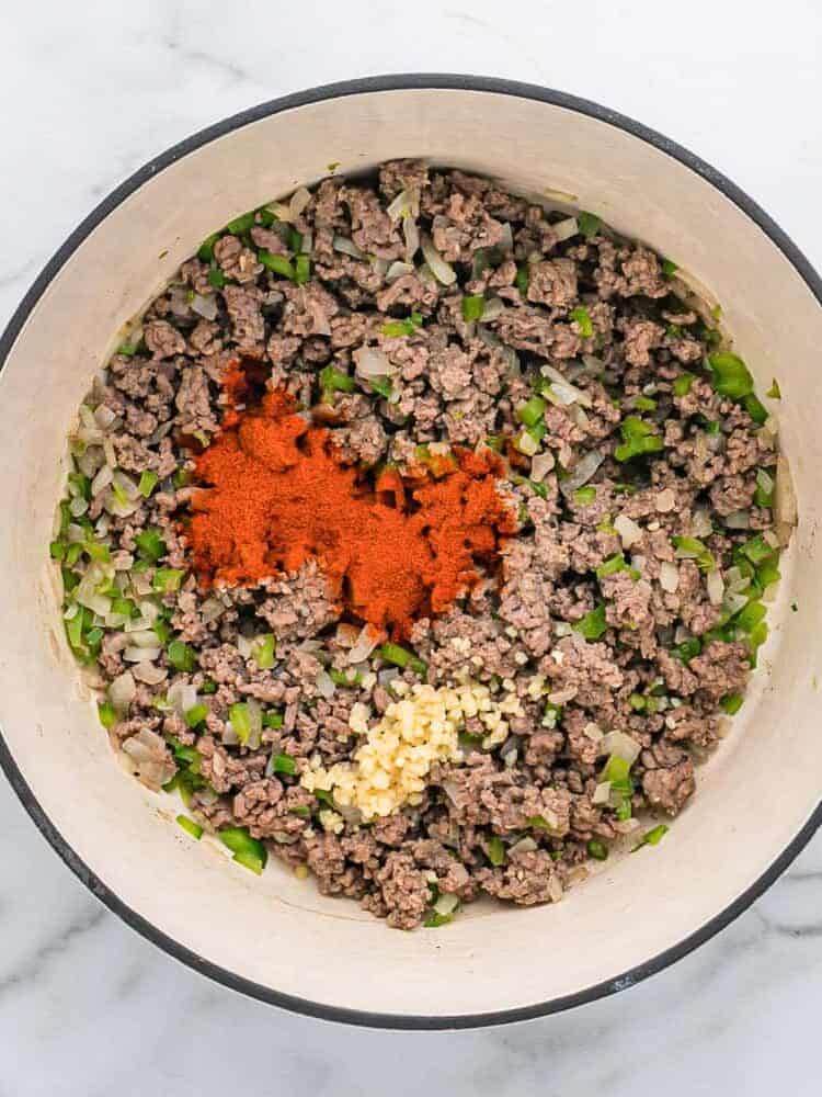 Cooked ground beef with spices added.