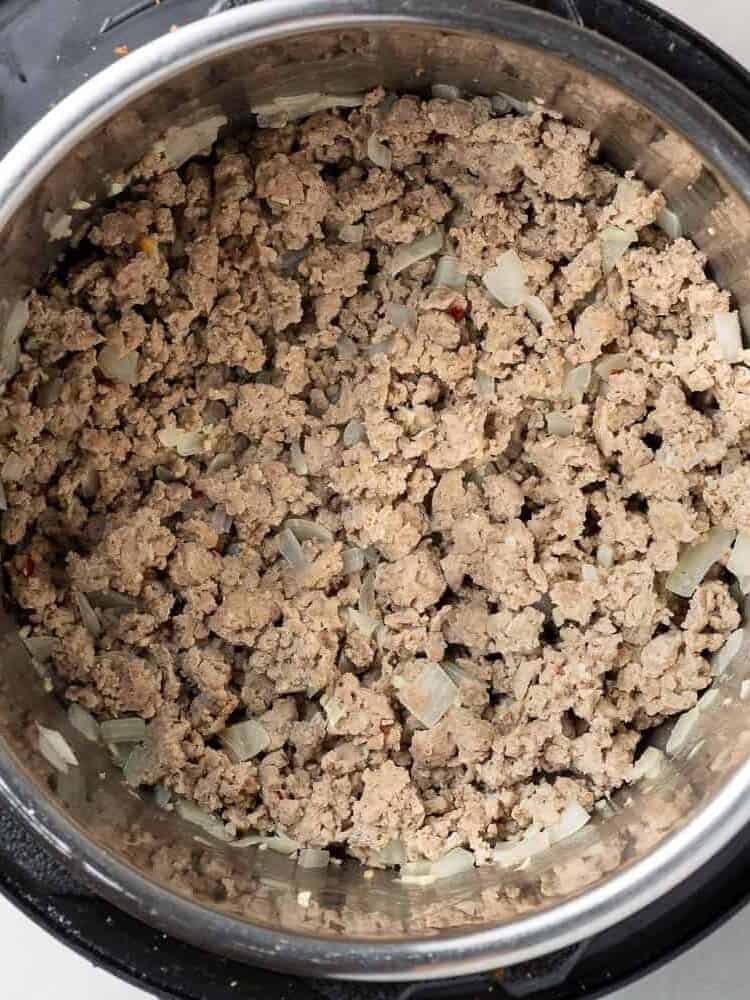 Browned ground chicken in an Instant Pot.